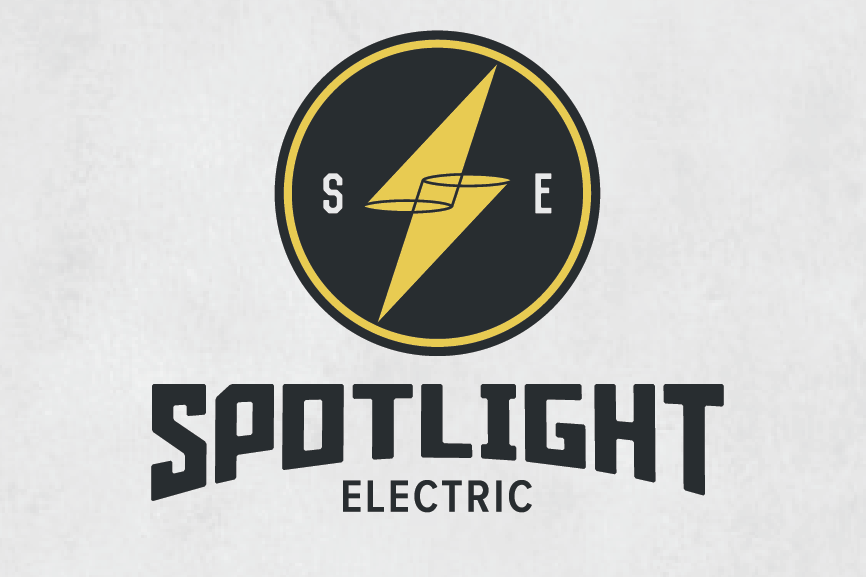 round  logo  with a yellow lighting bolt made of two cones and the text “spotlight electric”